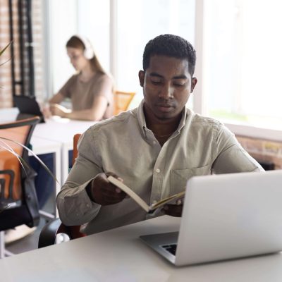 medium-shot-man-with-laptop-book